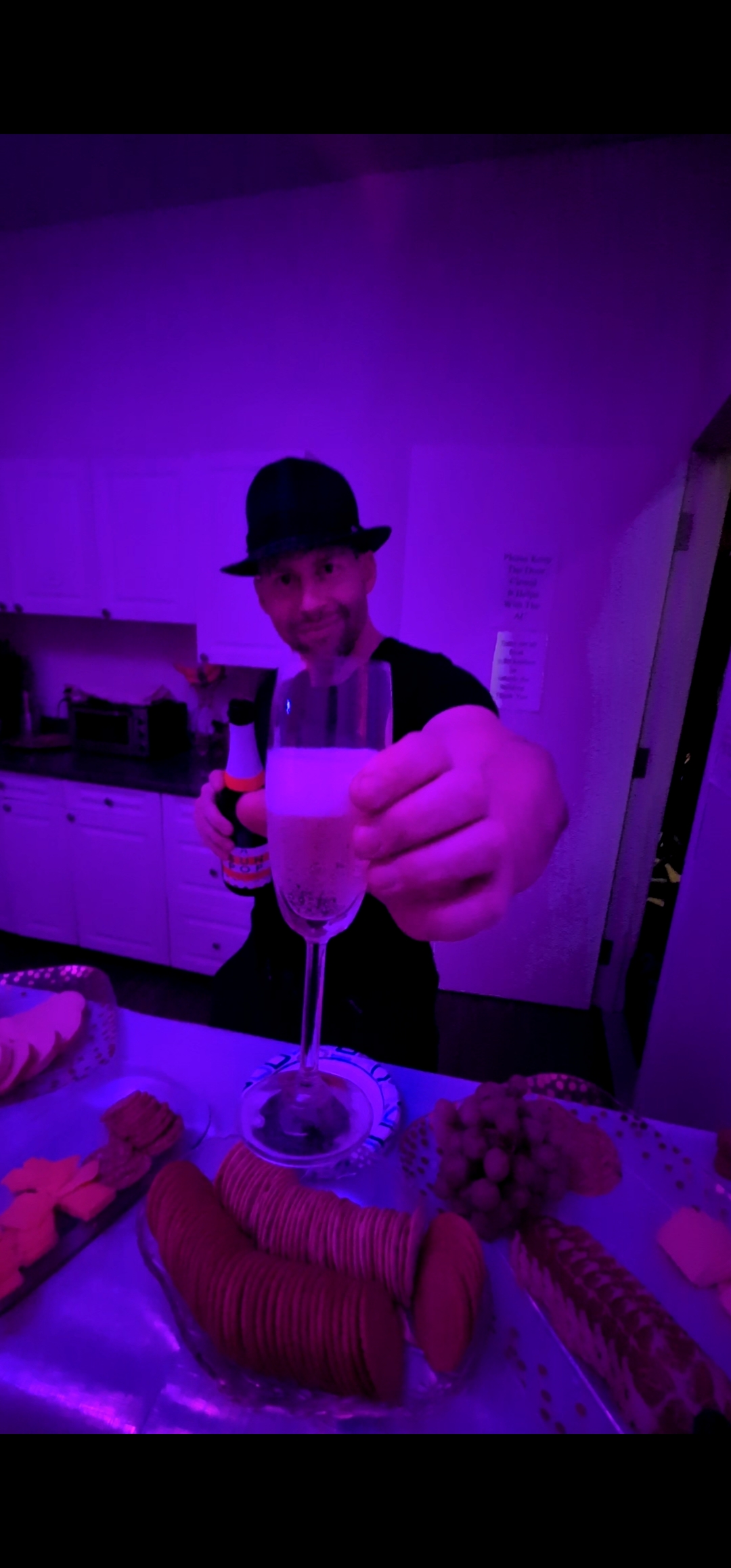 Entertainer in a bowler hat offering a champagne toast