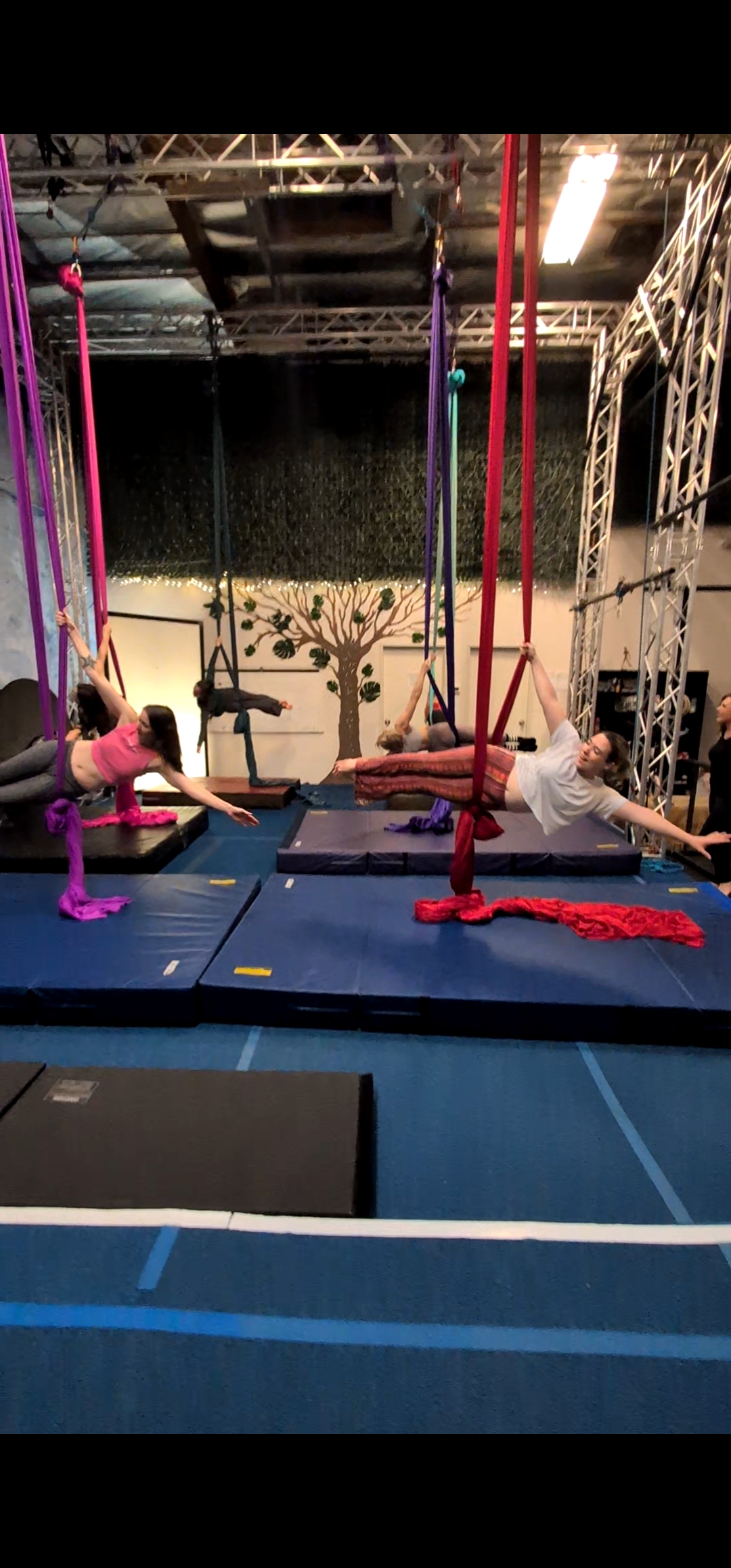Two guests in side splits on aerial silks